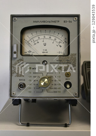 A millivoltmeter. Electronic devices. Voltage meter. An old electronic device. 129843539