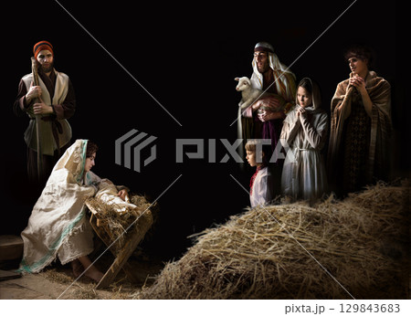 Mary sits in the stable near the manger with the baby 129843683