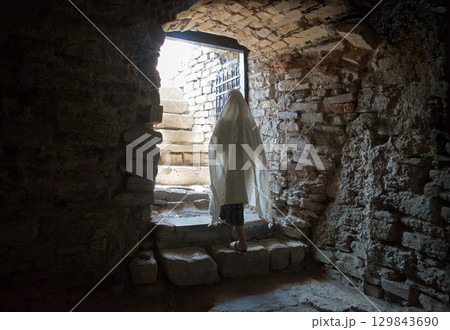 A person emerges from a dark dungeon 129843690