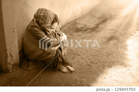 Frozen girl sitting on the floor 129843703