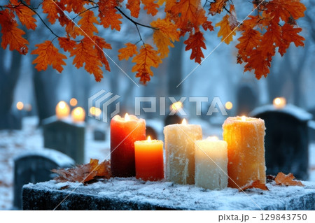 A Serene Winter Candlelit Cemetery Adorned with Beautiful Autumn Leaves and Warm Lights 129843750