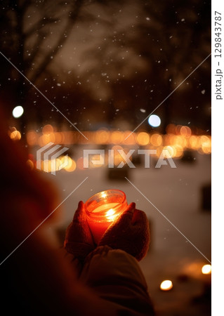 A Candlelight Vigil taking place amidst the serene Winter Snow creates a special atmosphere 129843787