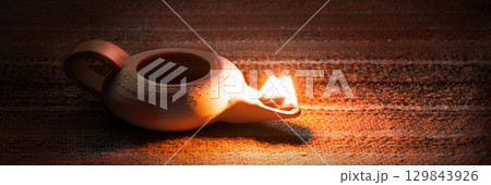 Ancient lamp shines in the dark Ancient lamp shines in the dark 129843926