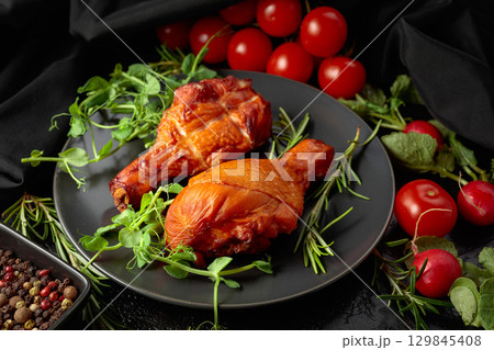 Smoked chicken drumsticks with greens and vegetables. 129845408