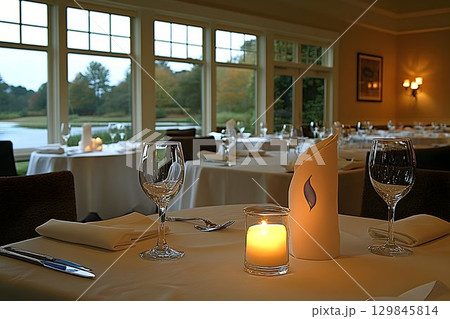 Elegant Restaurant Table Setting with Candlelight and Scenic Window View 129845814