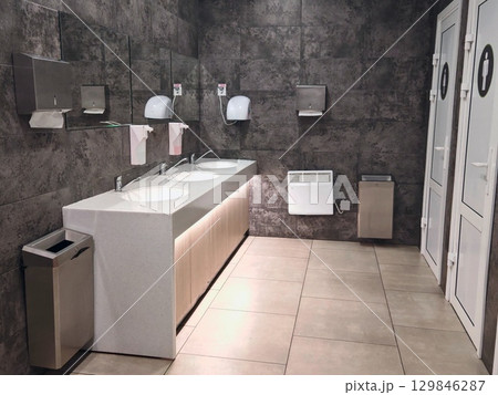 Interior public toilet. Contemporary interior of public toilet. grey-white Interior public toilet. Contemporary interior of public toilet. grey-white 129846287