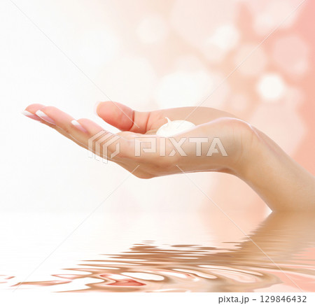 Female hand against an abstract background 129846432