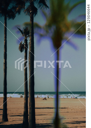 Summer beach and high palm trees. Sea, ocean shore, seaside. Summertime vacations, holidays Travel postcard double exposure. Travel postcard. 129846644