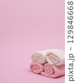 Stack of towels on pink background 129846668