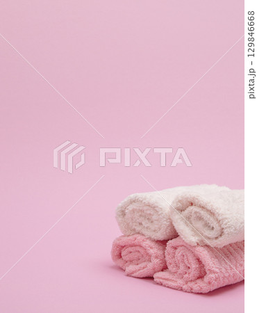 Stack of towels on pink background Stack of towels on pink background 129846668