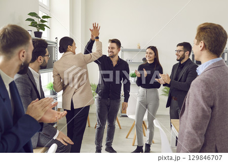 People gh fives congratulating each other on business achievements and excellent results at work. 129846707