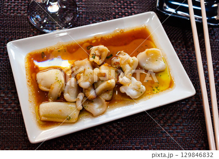 Appetizer cooked fried sepia with spicy sauce. Japanese food Appetizer cooked fried sepia with spicy sauce. Japanese food 129846832