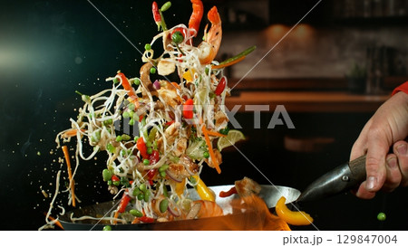 Freeze Motion of Flying Asian Wok Ingredients with Fire Flames 129847004