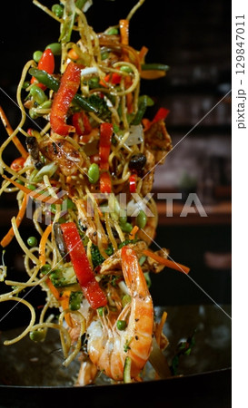 Freeze Motion of Flying Asian Wok Ingredients with Fire Flames Freeze Motion of Flying Asian Wok Ingredients with Fire Flames 129847011