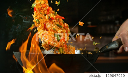Freeze Motion of Flying Asian Wok Ingredients with Fire Flames 129847020