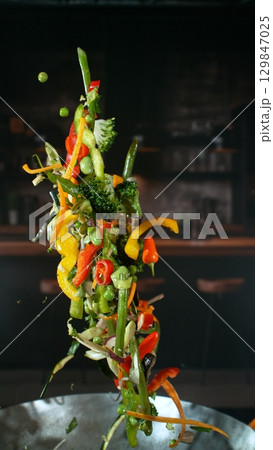 Freeze Motion of Flying Asian Wok Ingredients with Fire Flames 129847025