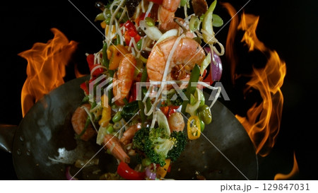 Freeze Motion of Flying Asian Wok Ingredients with Fire Flames 129847031