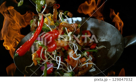 Freeze Motion of Flying Asian Wok Ingredients with Fire Flames 129847032