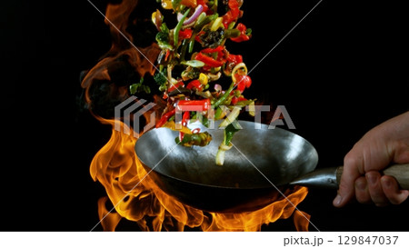 Freeze Motion of Flying Asian Wok Ingredients with Fire Flames 129847037