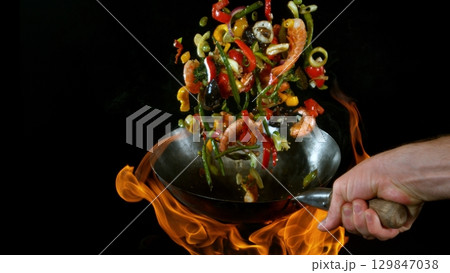 Freeze Motion of Flying Asian Wok Ingredients with Fire Flames Freeze Motion of Flying Asian Wok Ingredients with Fire Flames 129847038