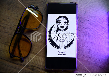 Minimalist Desktop Essentials Reusable Bottle, Smartphone, Keys, Glasses, and Plant on Wooden 129847233