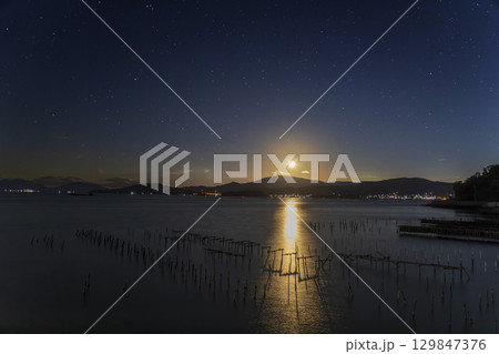 冬の瀬戸内に沈む月と星空 129847376