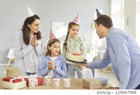 Happy birthday candle cake celebration, friendly family, parents and children party together  129847986