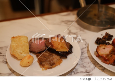 Assorted Grilled Meat and Bread on White Plate Assorted Grilled Meat and Bread on White Plate 129849708