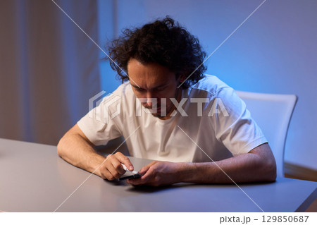 Cleaning a smartphone screen with a tissue needs attention for optimal hygiene and care 129850687