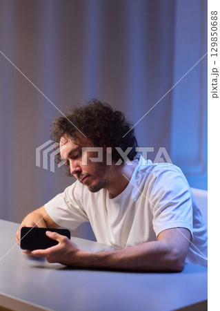 Cleaning a smartphone screen with a tissue needs attention for optimal hygiene and care 129850688