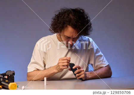 The Innovative Smartphone Cleaning Device is Being Demonstrated During Use and Functionality 129850706