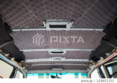 This is an Interior View of a Vehicle Ceiling which features Upholstered Panels and Structure This is an Interior View of a Vehicle Ceiling which features Upholstered Panels and Structure 129851152