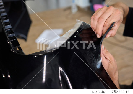 Applying a Protective Film on the Surface of Your Car for Enhanced Durability and Shine Applying a Protective Film on the Surface of Your Car for Enhanced Durability and Shine 129851155