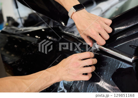 Applying a Protective Film on the Surface of Your Car for Enhanced Durability and Shine Applying a Protective Film on the Surface of Your Car for Enhanced Durability and Shine 129851168