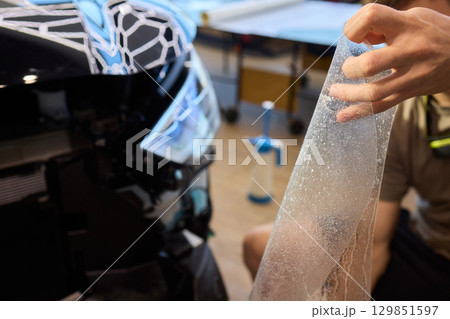 Applying a Protective Film on the Surface of Your Car for Enhanced Durability and Shine Applying a Protective Film on the Surface of Your Car for Enhanced Durability and Shine 129851597