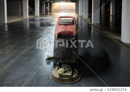 An Abandoned Cleaning Machine Lying Forgotten in a Dimly Lit Industrial Space with Grime and Dust An Abandoned Cleaning Machine Lying Forgotten in a Dimly Lit Industrial Space with Grime and Dust 129852254