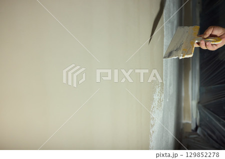 Applying a Fresh Layer of Paint to a Wall Using a Trowel for a Stunning and Beautiful Finish Applying a Fresh Layer of Paint to a Wall Using a Trowel for a Stunning and Beautiful Finish 129852278