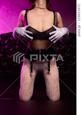 Elegant Seduction A Captivating and Charming Pose in Stylish and Alluring Lingerie 129852672