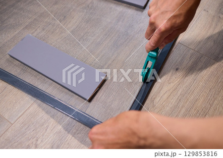 The process of cutting vinyl flooring accurately is essential for achieving a perfect fit 129853816