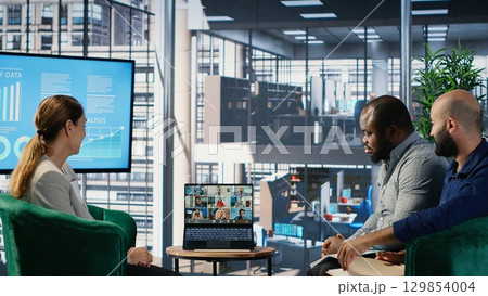 Remote meeting between corporate leaders for a professional discussion, sharing insights to create a fruitful partnership between global companies. Collab via online video call. Camera B. Remote meeting between corporate leaders for a professional discussion, sharing insights to create a fruitful partnership between global companies. Collab via online video call. Camera B. 129854004