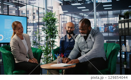 Business associates signing the partnership contract during the meeting, agreeing to terms and conditions and giving his authority. African american CEO gives consent with his signature. Camera A. Business associates signing the partnership contract during the meeting, agreeing to terms and conditions and giving his authority. African american CEO gives consent with his signature. Camera A. 129854044