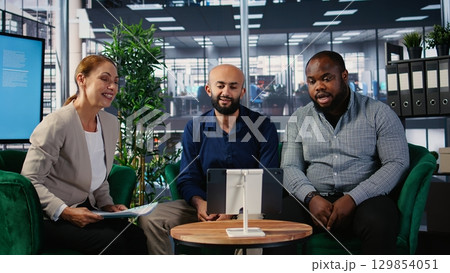 Corporate web video conference with diverse participants focused on goal oriented business growth, remote consulting and functional team interaction via online communication tools. Camera A. 129854051