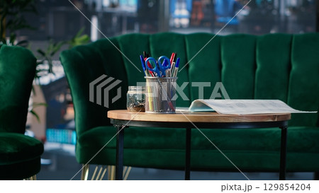 Business lobby featuring sofa in a bright modern boardroom with glass elements and high end furniture, organized for office life and structured to support meetings and corporate culture. 129854204