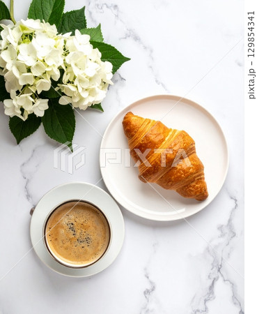 Croissant on plate and a glass of coffee in the morning coffee Croissant on plate and a glass of coffee in the morning coffee 129854341