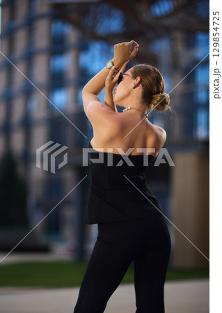 An Elegant Fashion Portrait Featuring a Beautiful Woman in a Stylish and Trendy Outfit An Elegant Fashion Portrait Featuring a Beautiful Woman in a Stylish and Trendy Outfit 129854725