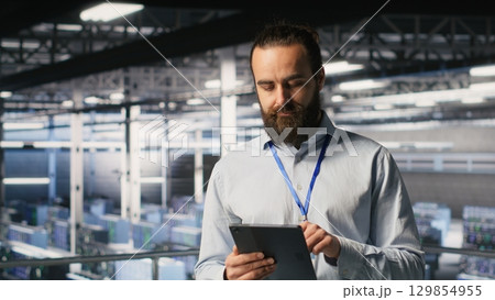 Computer scientists in data center monitoring neural network LLM visualization. Industrial server farm IT professionals overseeing rigs powering machine learning processes 129854955