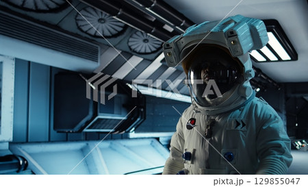 Astronaut walking in orbital station travelling to Mars, mapping unknown worlds. Cosmonaut in spaceship preparing to explore planetary surface, advancing scientific knowledge, camera A Astronaut walking in orbital station travelling to Mars, mapping unknown worlds. Cosmonaut in spaceship preparing to explore planetary surface, advancing scientific knowledge, camera A 129855047