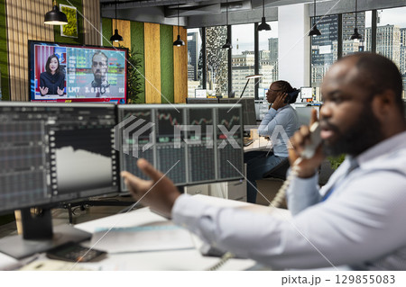 Prop firm traders watching breaking news of unexpected crisis affecting stock market valuations, worried about losing money. Stockbrokers alerted by Black Swan event upset causing global disruption 129855083