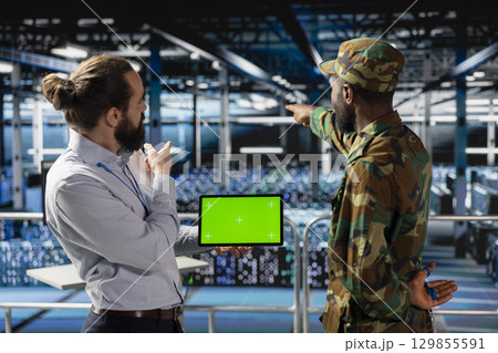 Military personnel overseeing AI computing operations on isolated screen in high tech server facility. Army tech experts using copy space screen to oversee communication systems. Military personnel overseeing AI computing operations on isolated screen in high tech server facility. Army tech experts using copy space screen to oversee communication systems. 129855591