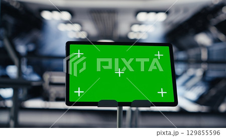 Close up of green screen tablet inside futuristic spacecraft bay used for monitoring system diagnostics. Chroma key device used for orbital navigation data in space station cockpit 129855596